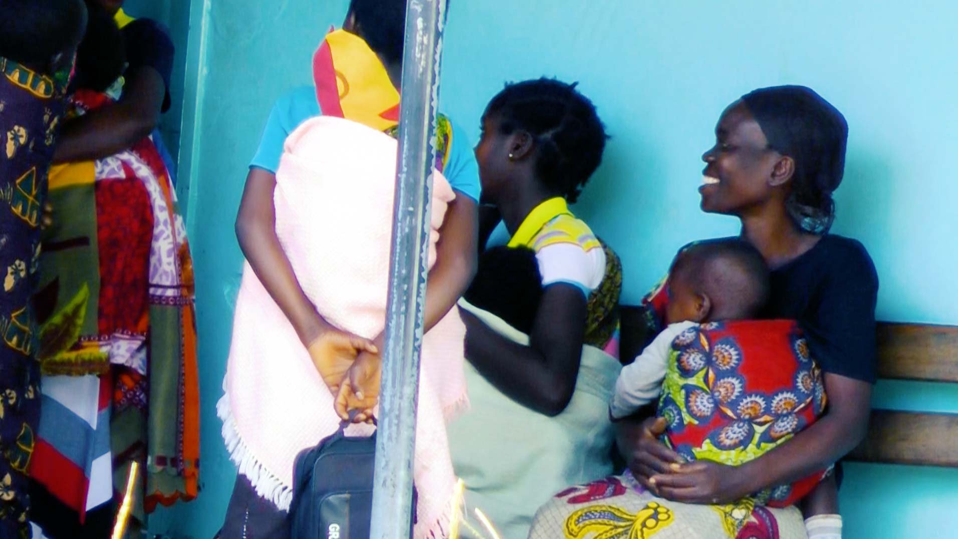 Women and children sitting outside